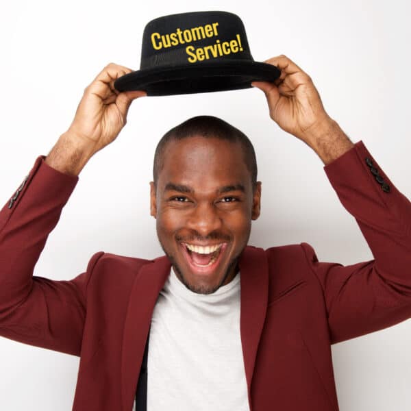Smiling man putting on a customer service hat