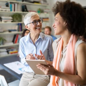 Happy female business owners casually talking in meeting room